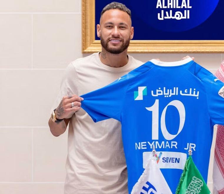 Neymar Jr holding an Al Hilal shirt